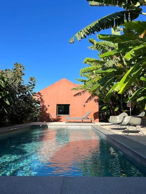The Banana House in Arco da Calheta. Basalt walls, banana grove, architecture that dissolves into the volcanic terrain.